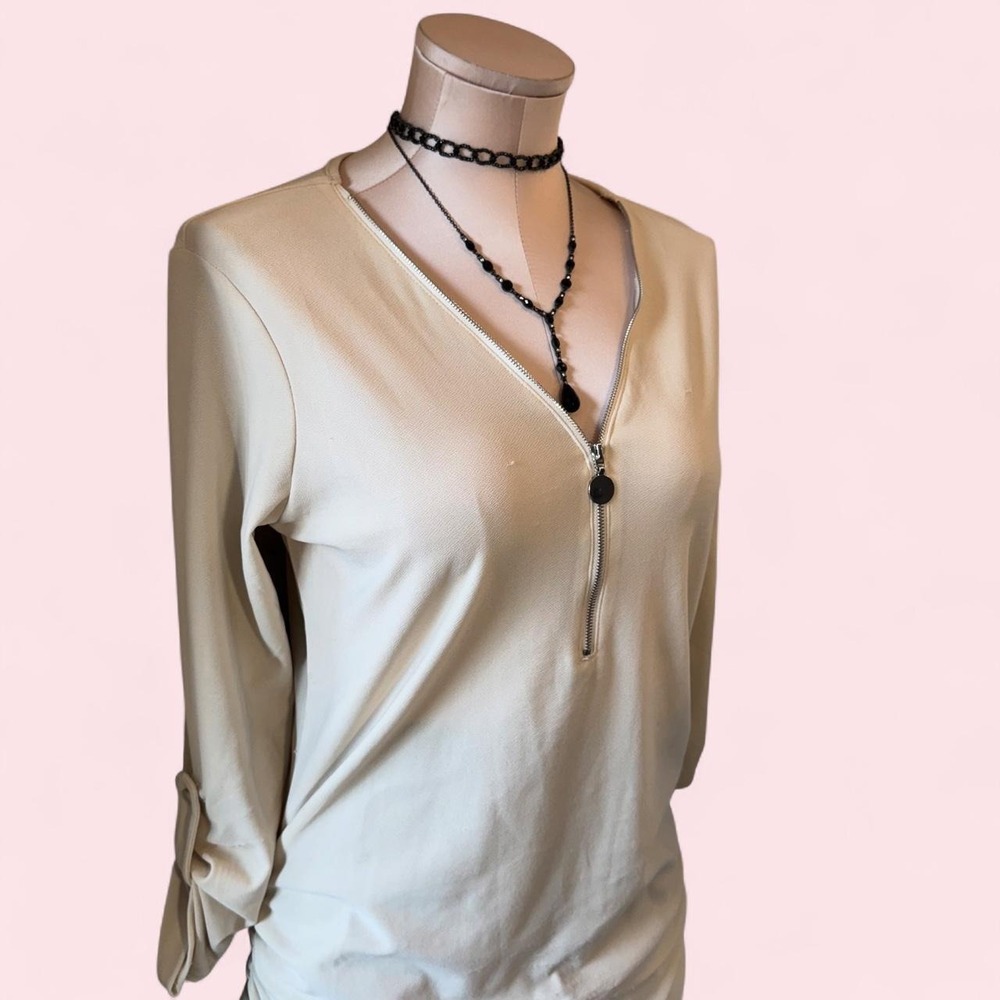 Cream long sleeve‎ blouse with a flattering draped fit
